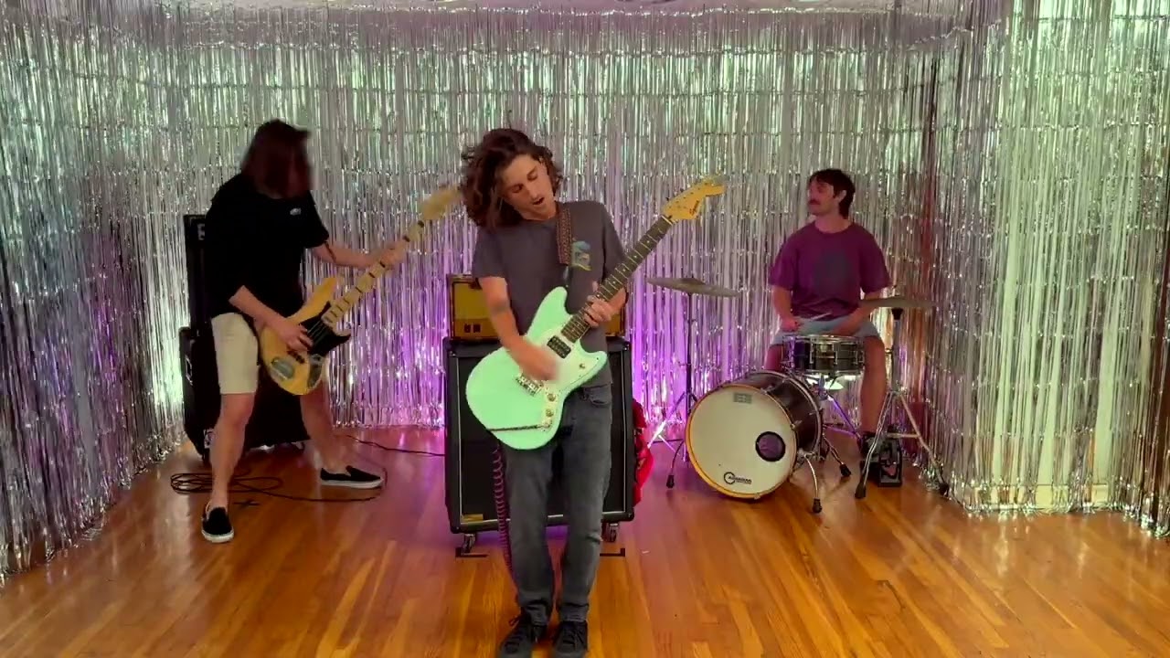 Scuff Up playing in front of a silver tinsel curtain